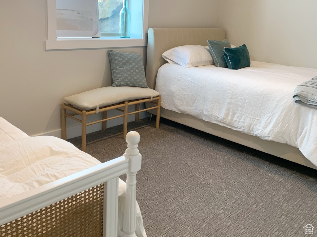 Bedroom featuring dark carpet