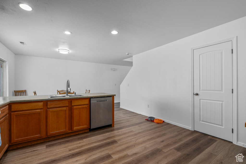 Kitchen featuring sink, dark wood-type flooring, and dishwasher
