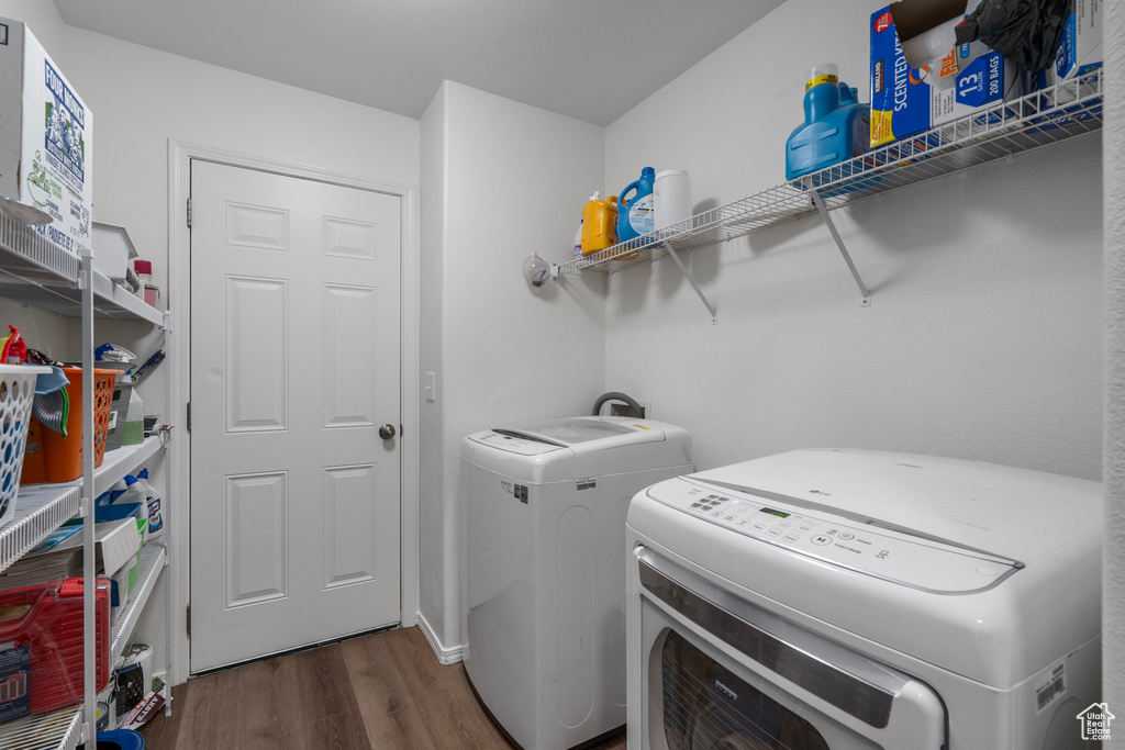Laundry room with dark hardwood / wood-style flooring and separate washer and dryer