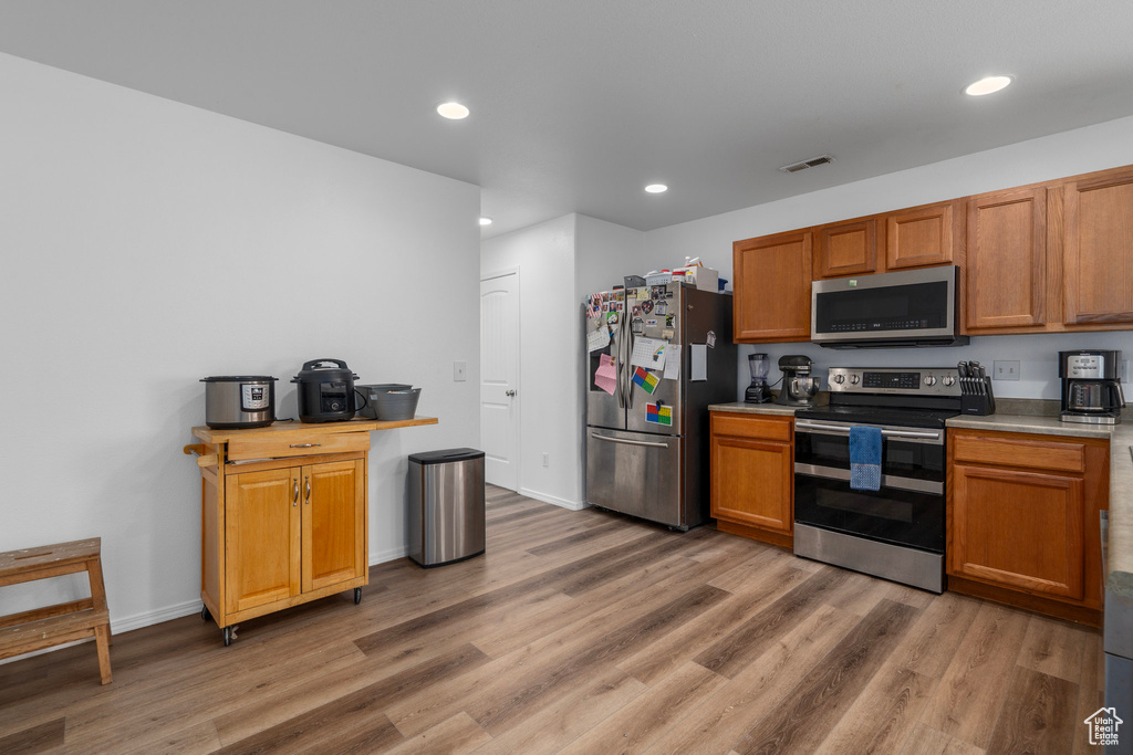 Kitchen featuring light hardwood / wood-style floors and stainless steel appliances