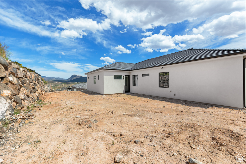 Rear view of property with a mountain view