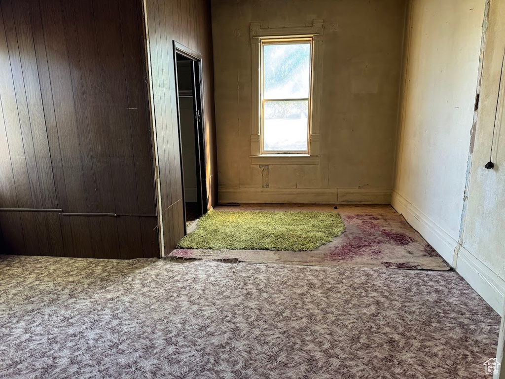 Interior space featuring carpet floors and wooden walls