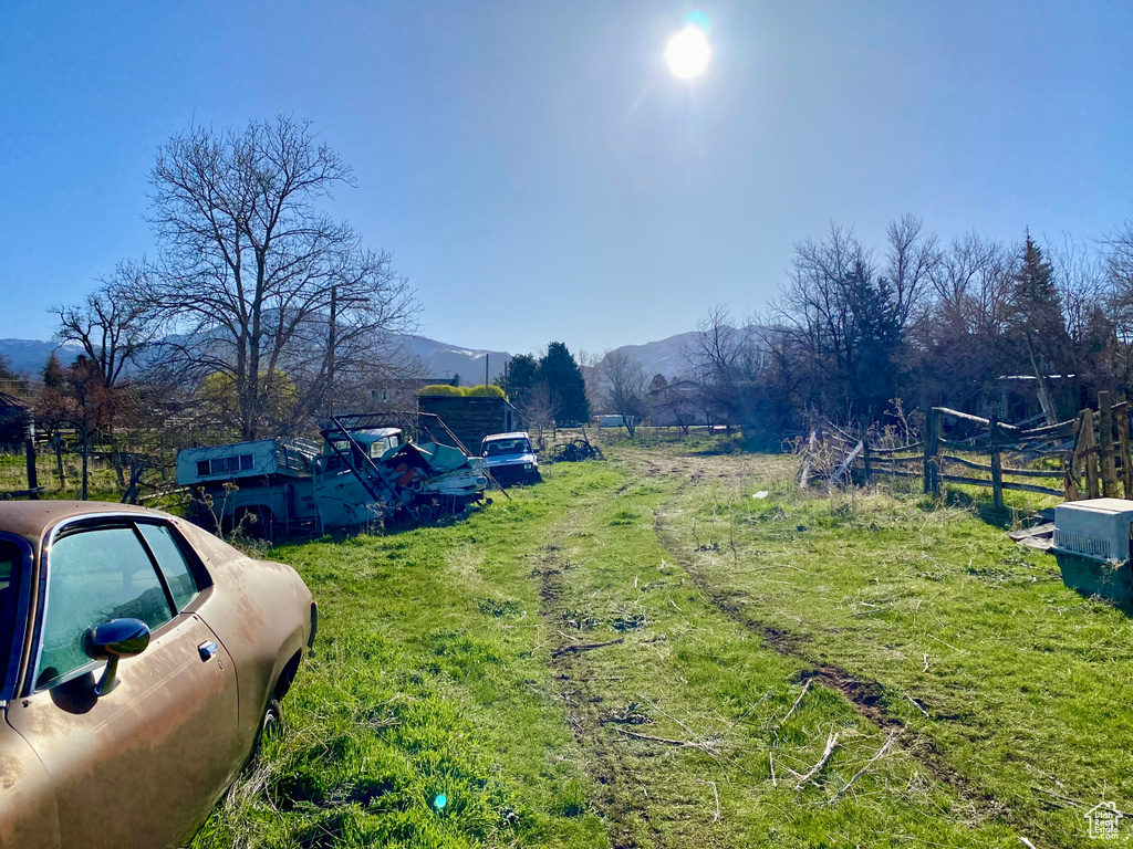 View of yard with a rural view and a mountain view