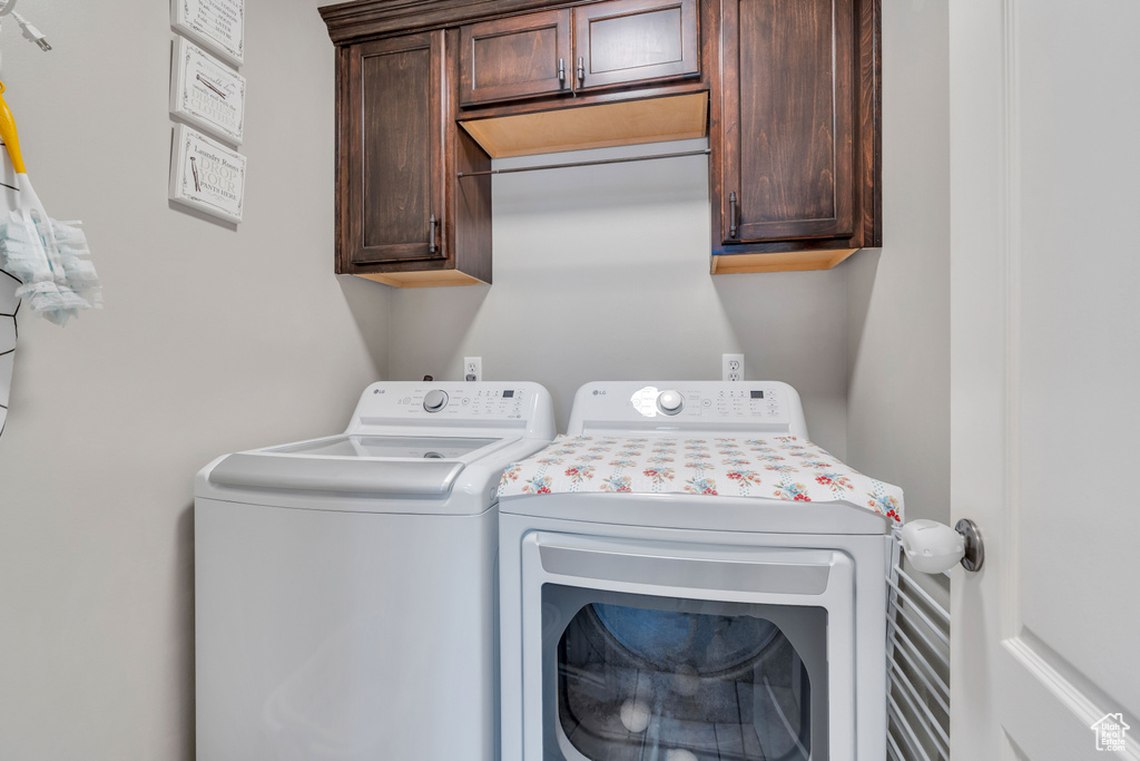 Clothes washing area with cabinets and washing machine and dryer