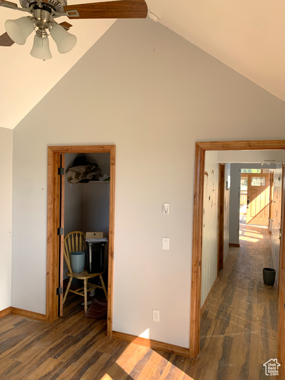 Hallway featuring dark hardwood / wood-style flooring and vaulted ceiling