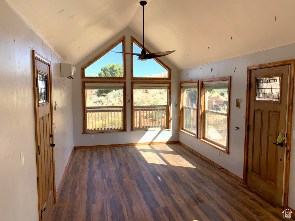 Foyer with ceiling fan, high vaulted ceiling, and dark wood-type flooring