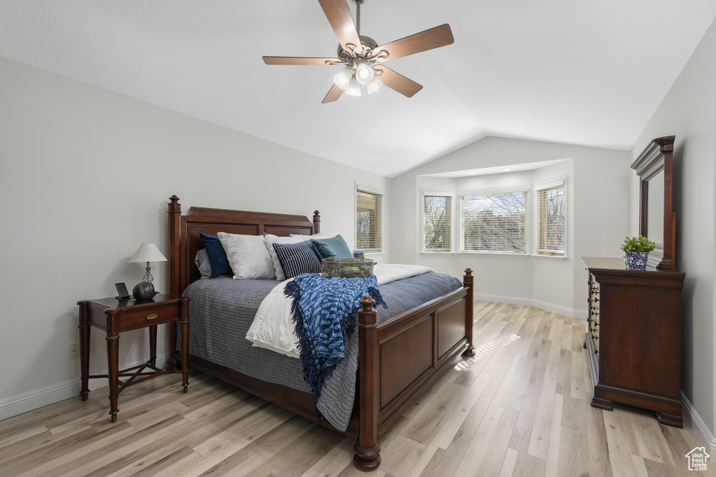 Bedroom with ceiling fan, vaulted ceiling, and light hardwood / wood-style floors