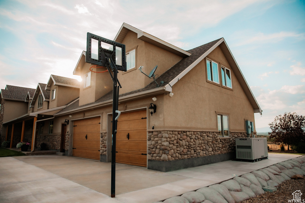 View of side of home featuring a garage