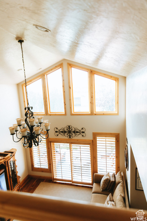 Living room featuring hardwood / wood-style floors, a notable chandelier, and a wealth of natural light