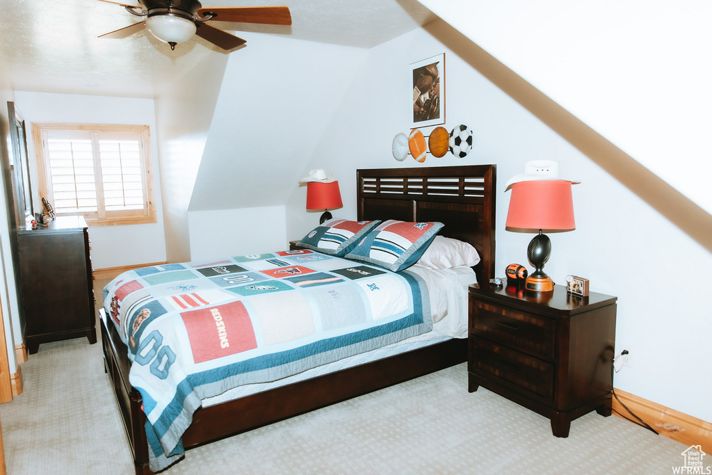 Bedroom with light colored carpet and ceiling fan