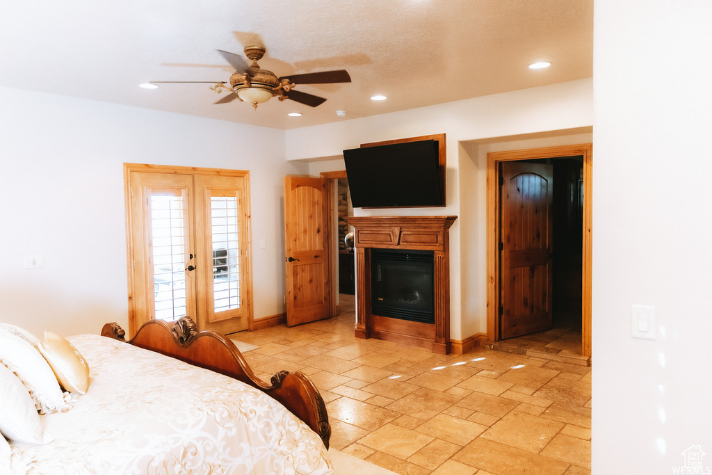 Bedroom featuring french doors, ceiling fan, light tile floors, and access to outside