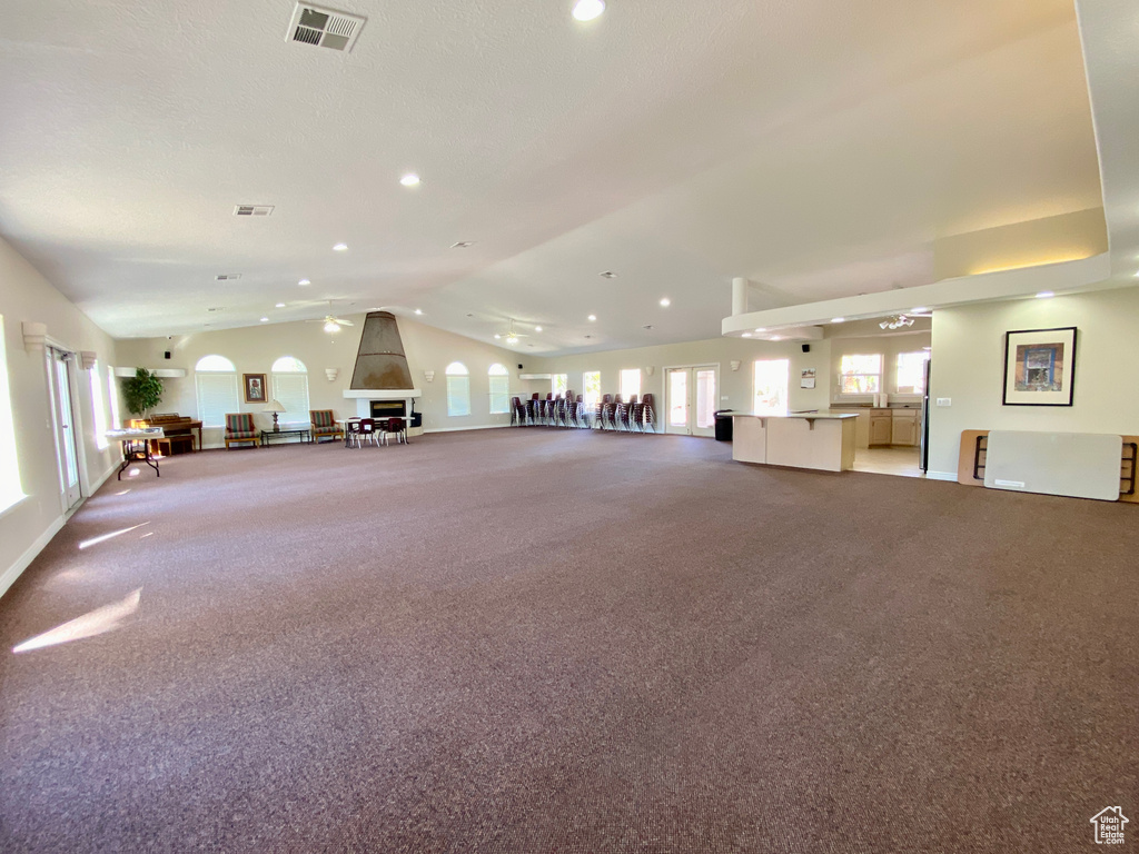 Interior space featuring light colored carpet and vaulted ceiling