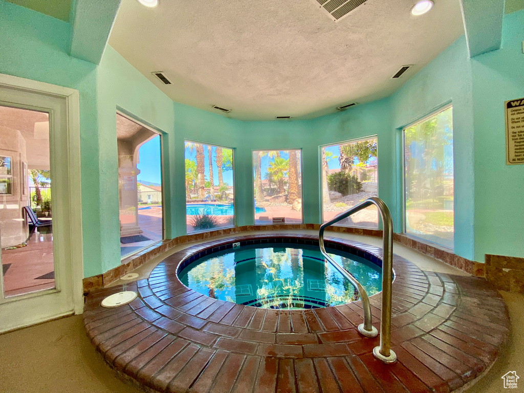 View of swimming pool featuring an indoor in ground hot tub
