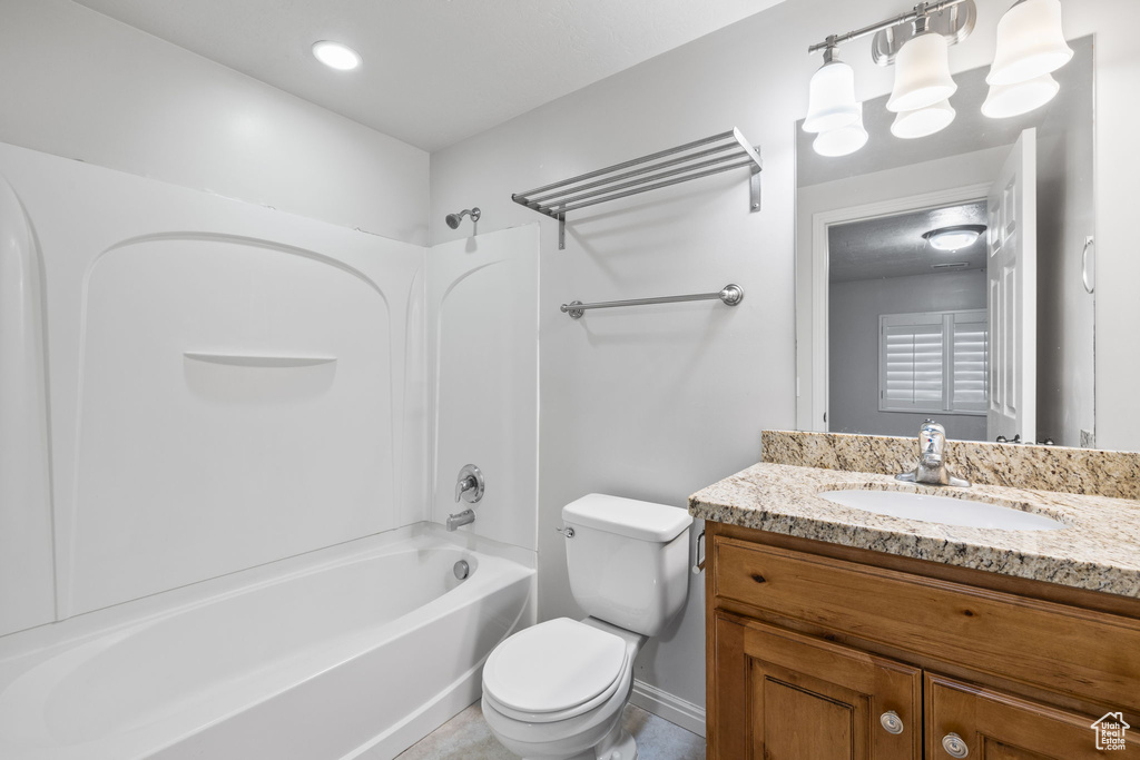 Full bathroom with tile flooring, bathtub / shower combination, toilet, and vanity