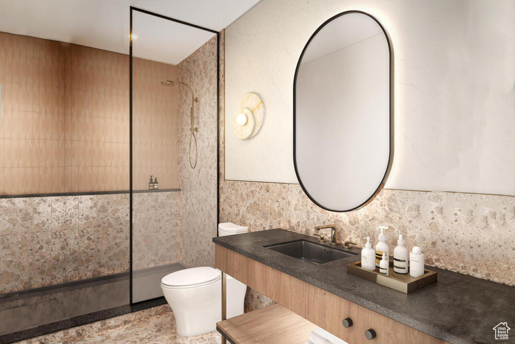 Bathroom with tile floors, vanity, tile walls, backsplash, and toilet