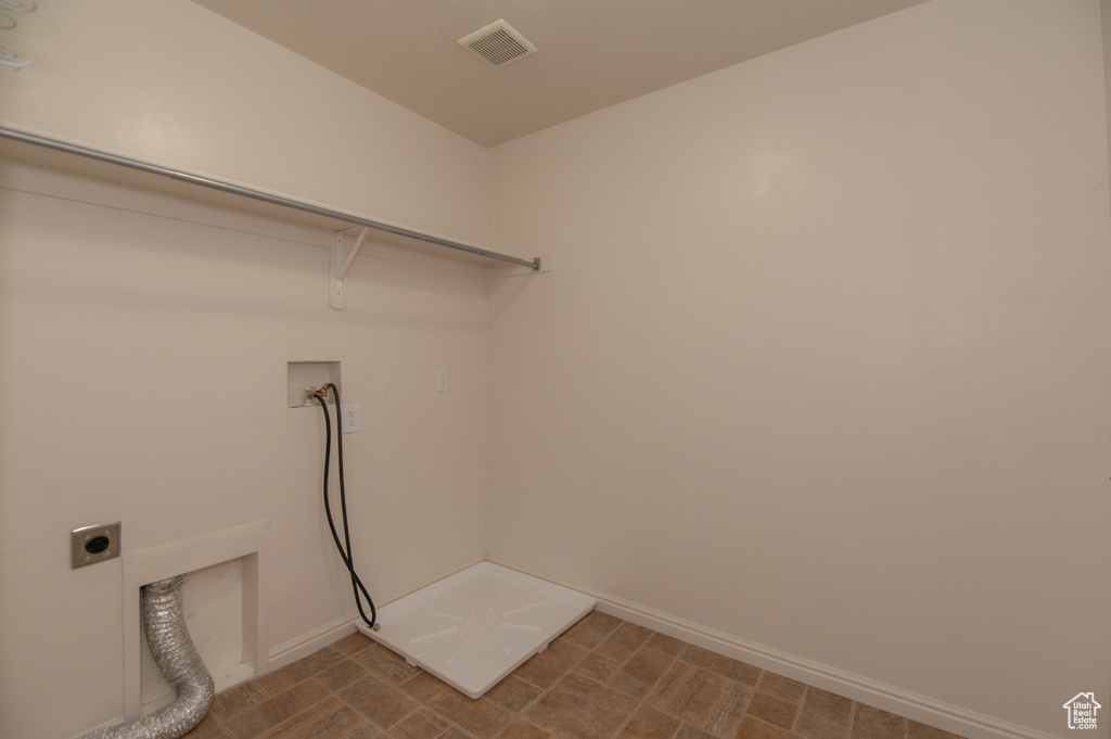 Clothes washing area with washer hookup, hookup for an electric dryer, and tile flooring
