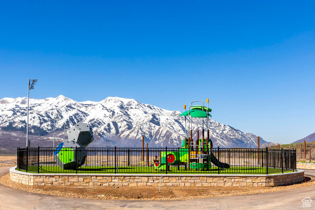 View of jungle gym with a mountain view