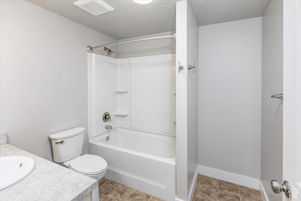 Full bathroom featuring tile flooring, vanity, toilet, and bathing tub / shower combination
