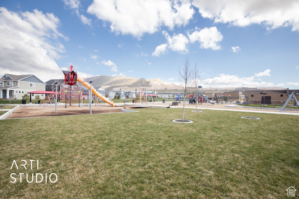 View of home\\\\\\\'s community with a mountain view, a lawn, and a playground