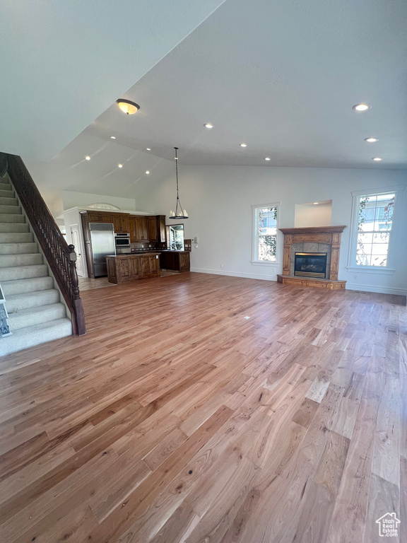 Unfurnished living room with a wealth of natural light and light hardwood / wood-style flooring