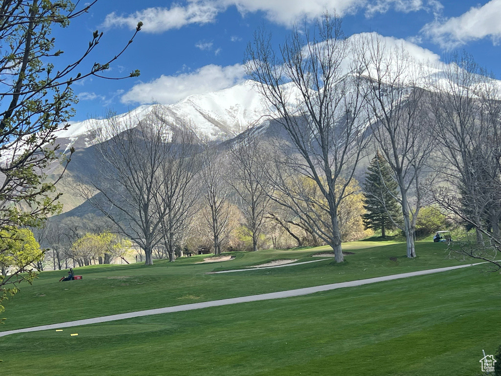 Exterior space with a mountain view and a lawn