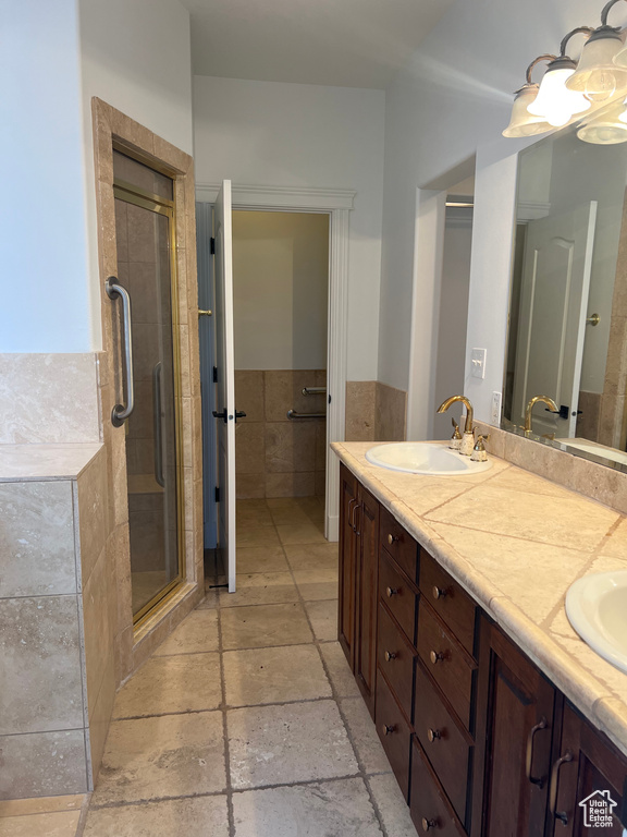 Bathroom with walk in shower, tile floors, and dual bowl vanity