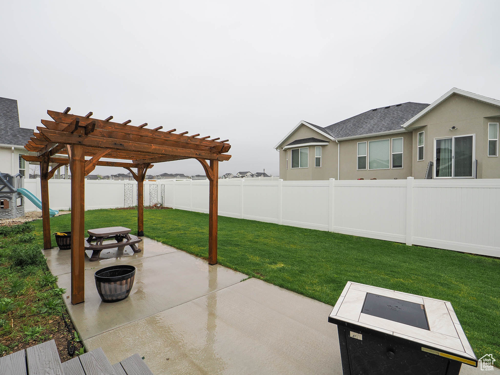 View of patio featuring an outdoor fire pit and a pergola
