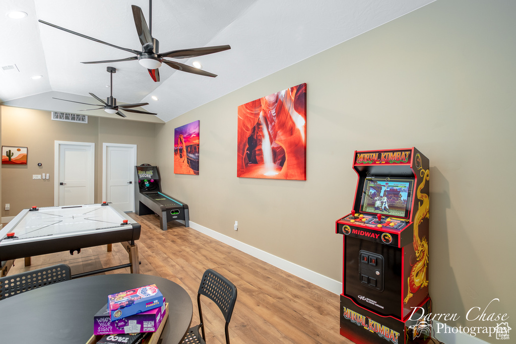 Playroom featuring lofted ceiling, ceiling fan, and light hardwood / wood-style floors