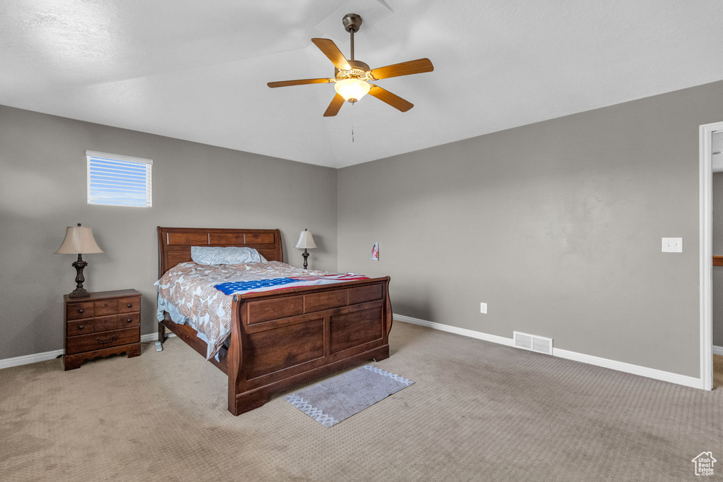 Bedroom with ceiling fan and light carpet