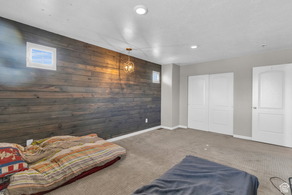 Interior space with dark colored carpet and wood walls