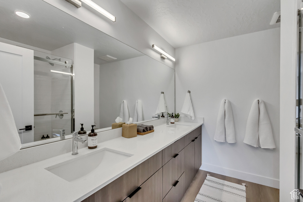Bathroom with wood-type flooring and double vanity