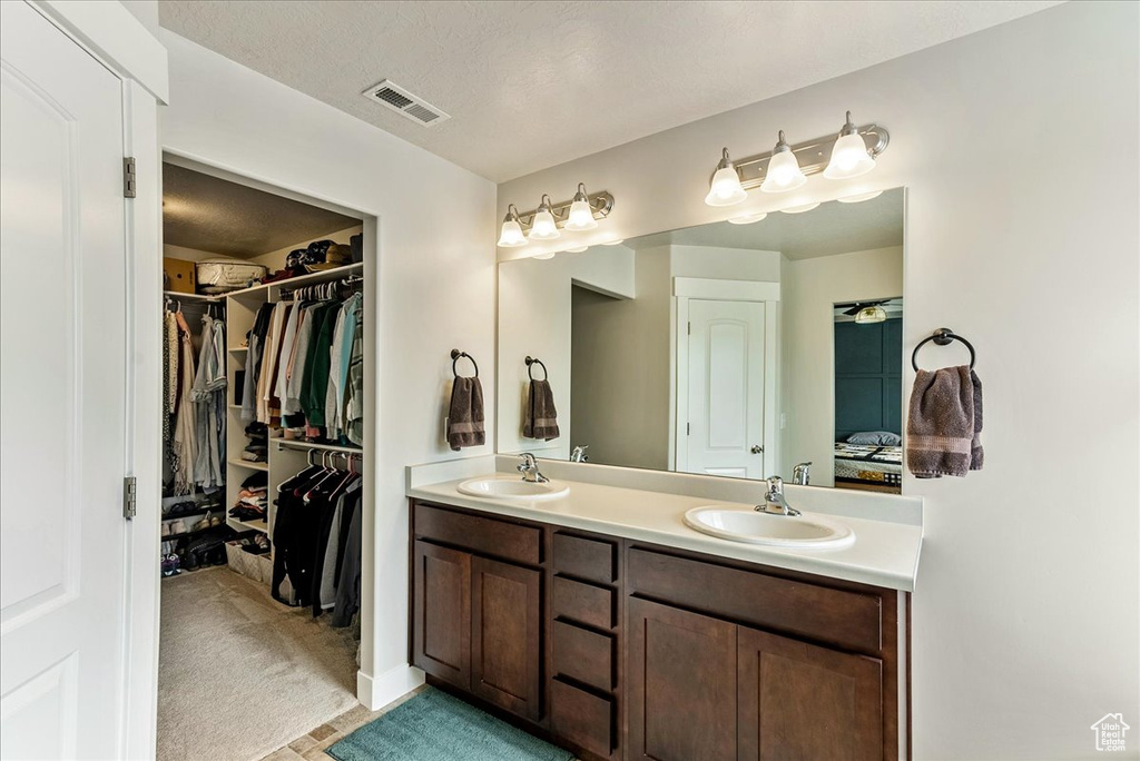Bathroom with dual sinks and oversized vanity