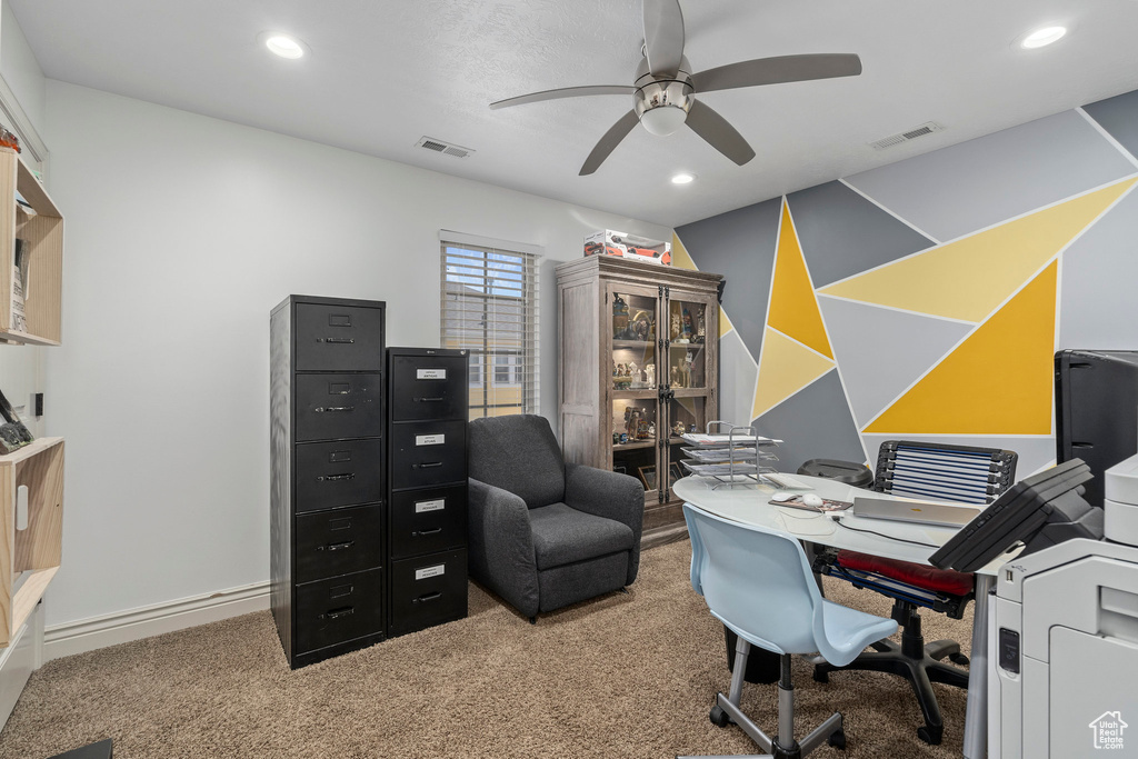 Office space featuring light colored carpet and ceiling fan