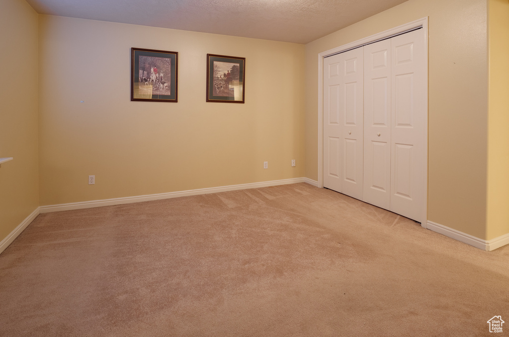 Unfurnished bedroom featuring light carpet