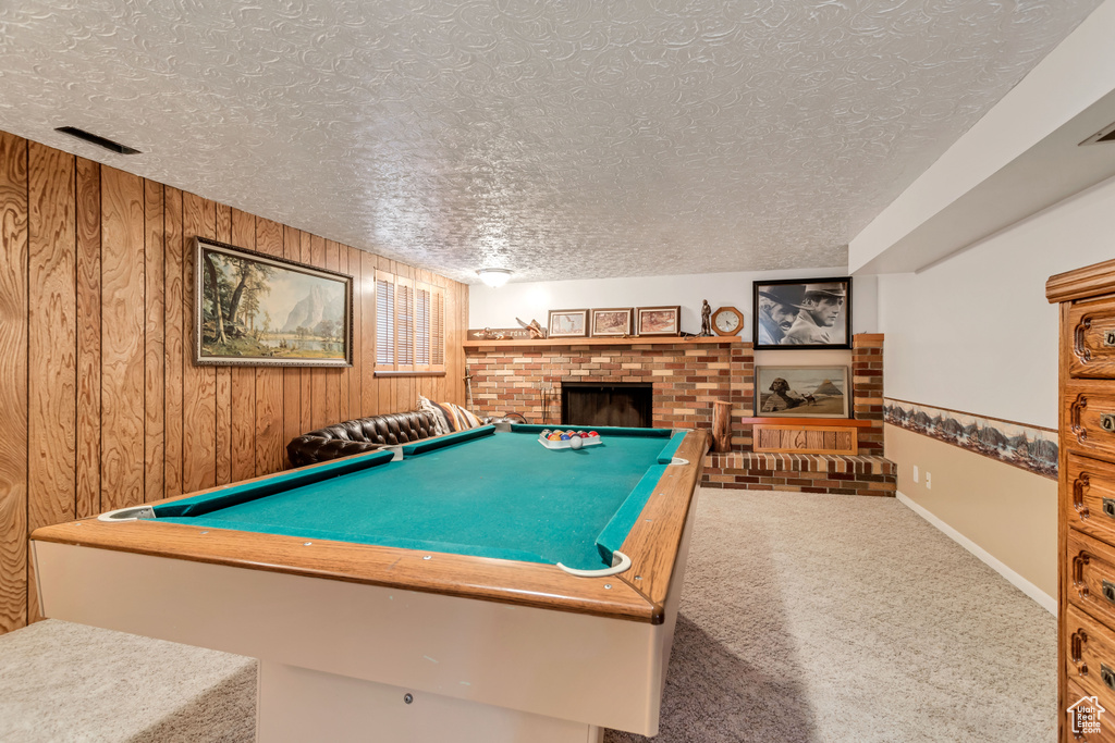 Playroom with a fireplace, pool table, a textured ceiling, and carpet flooring