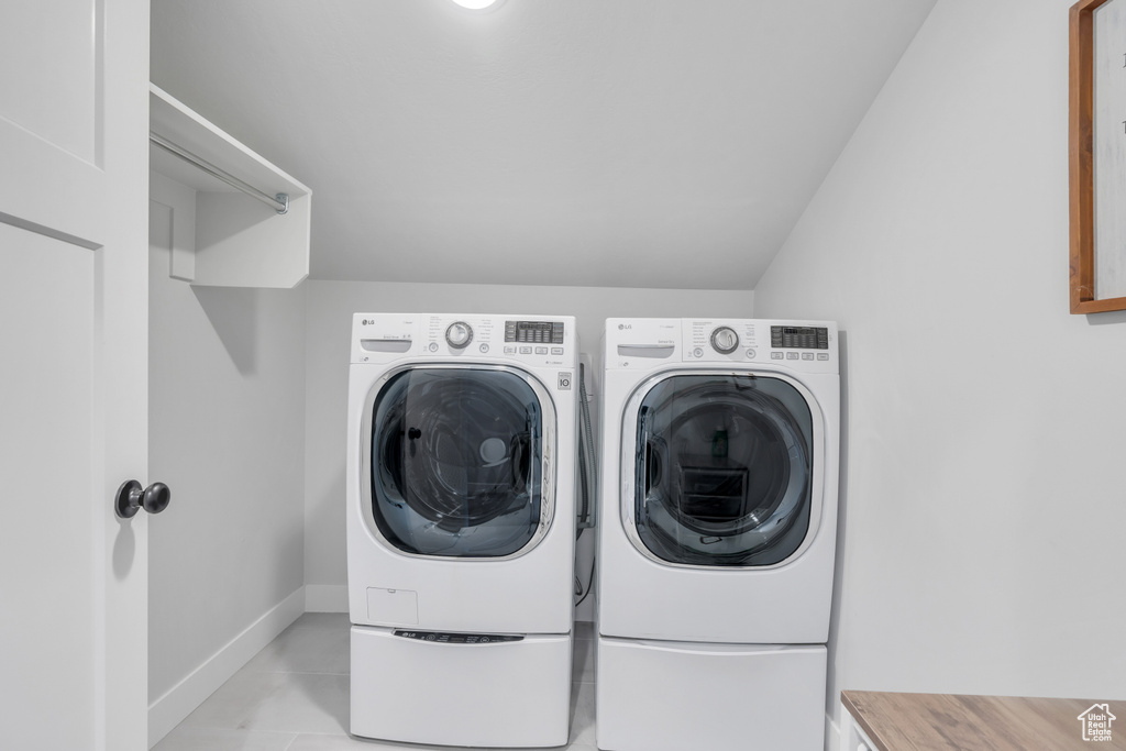 Laundry area featuring independent washer and dryer and light tile floors