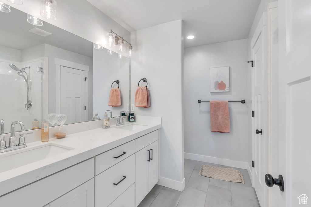 Bathroom with tile floors and dual vanity