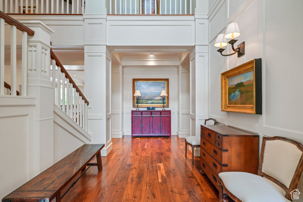 Entryway featuring dark hardwood / wood-style flooring and a towering ceiling