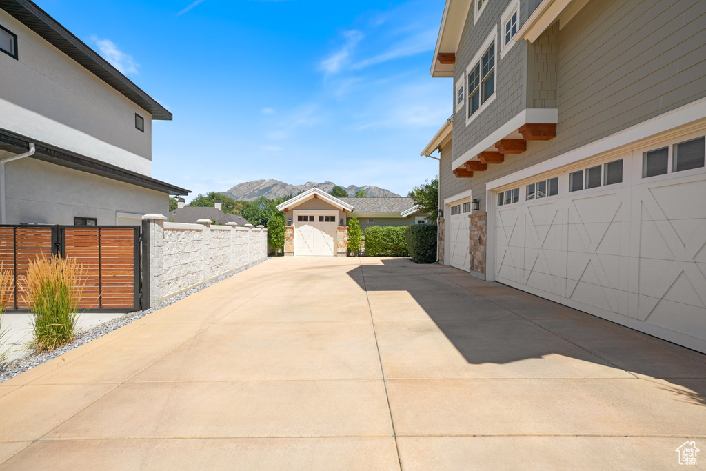View of property exterior featuring a mountain view and a garage