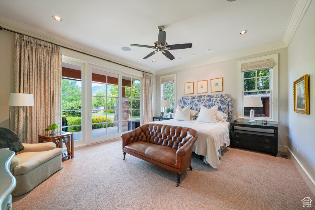 Bedroom featuring ceiling fan, access to exterior, and multiple windows