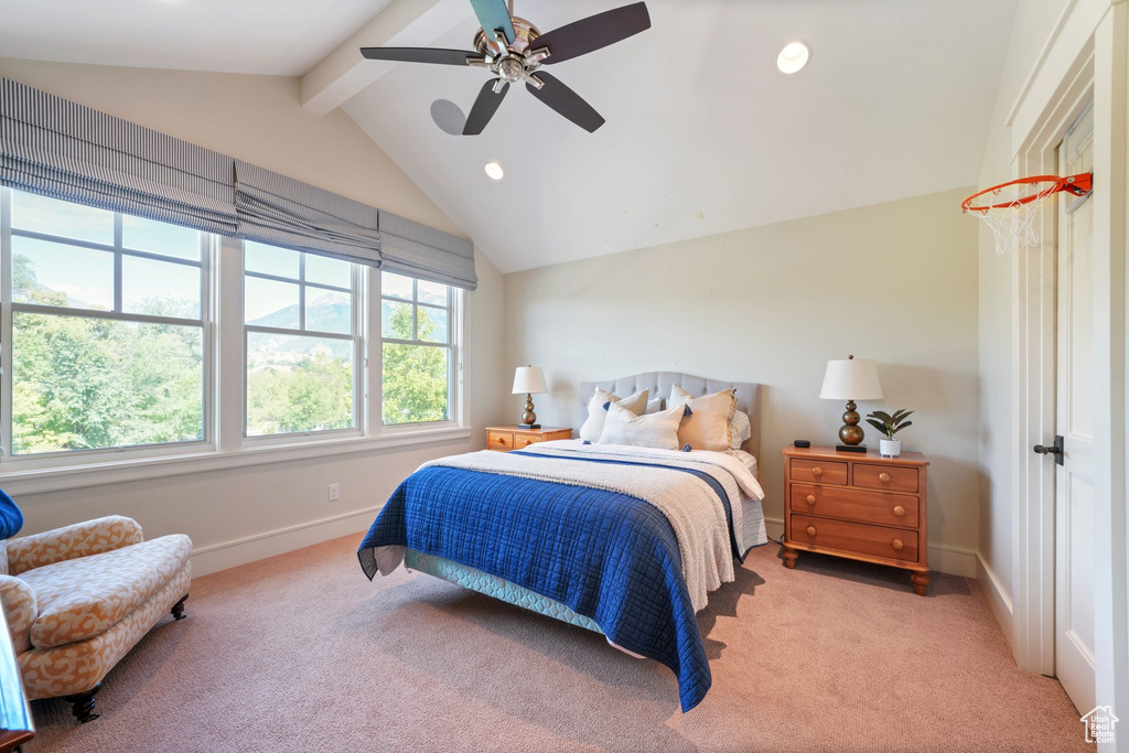 Carpeted bedroom with lofted ceiling with beams and ceiling fan