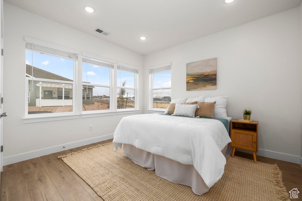 Bedroom with wood-type flooring