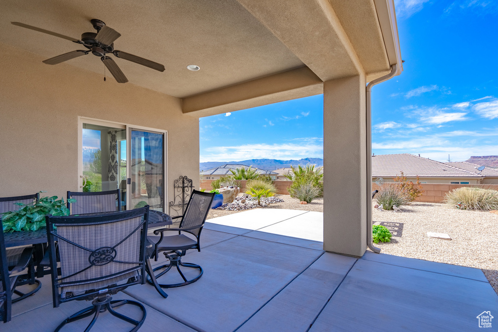View of patio with ceiling fan and a mountain view
