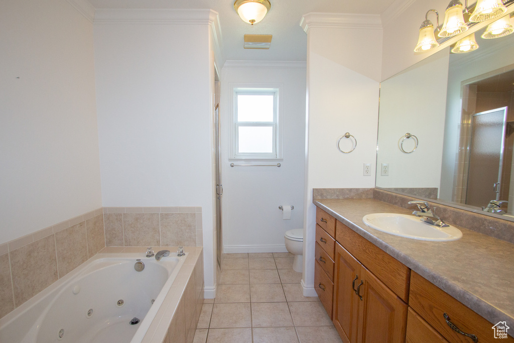 Bathroom with tiled tub, crown molding, toilet, tile flooring, and vanity