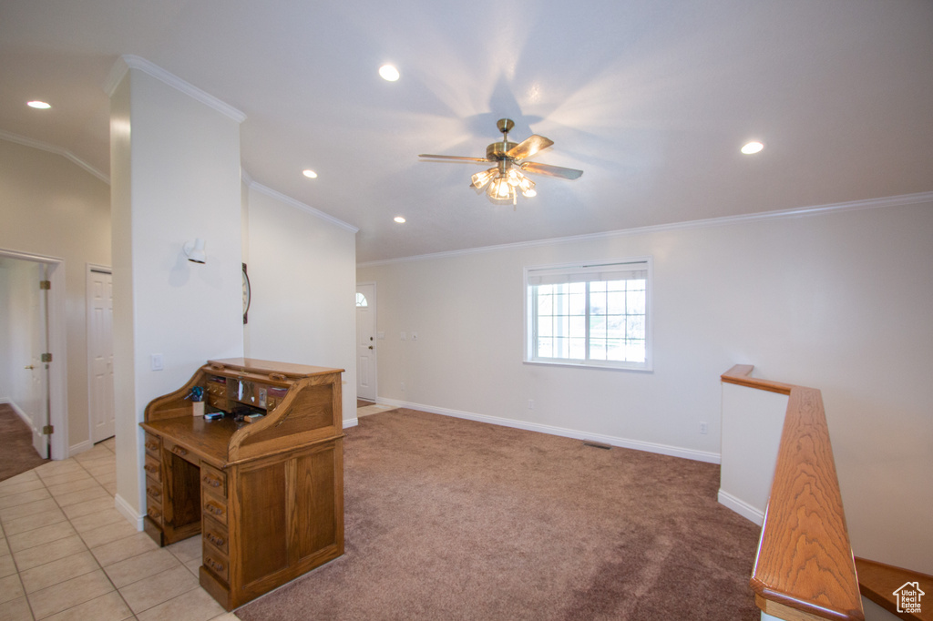 Interior space with ceiling fan, crown molding, and light tile floors
