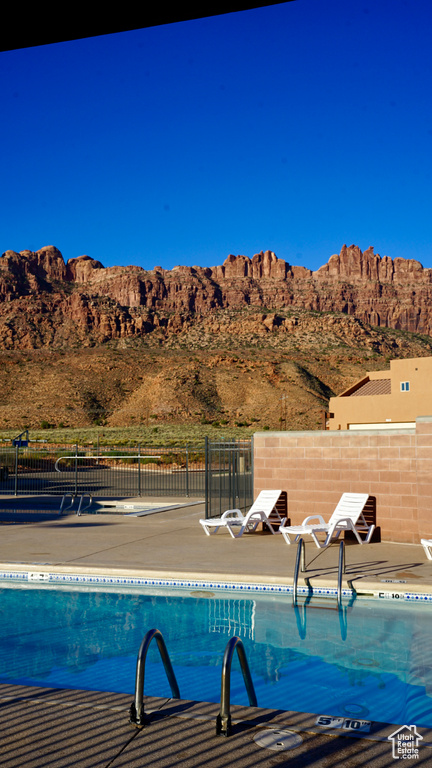 View of pool with a mountain view