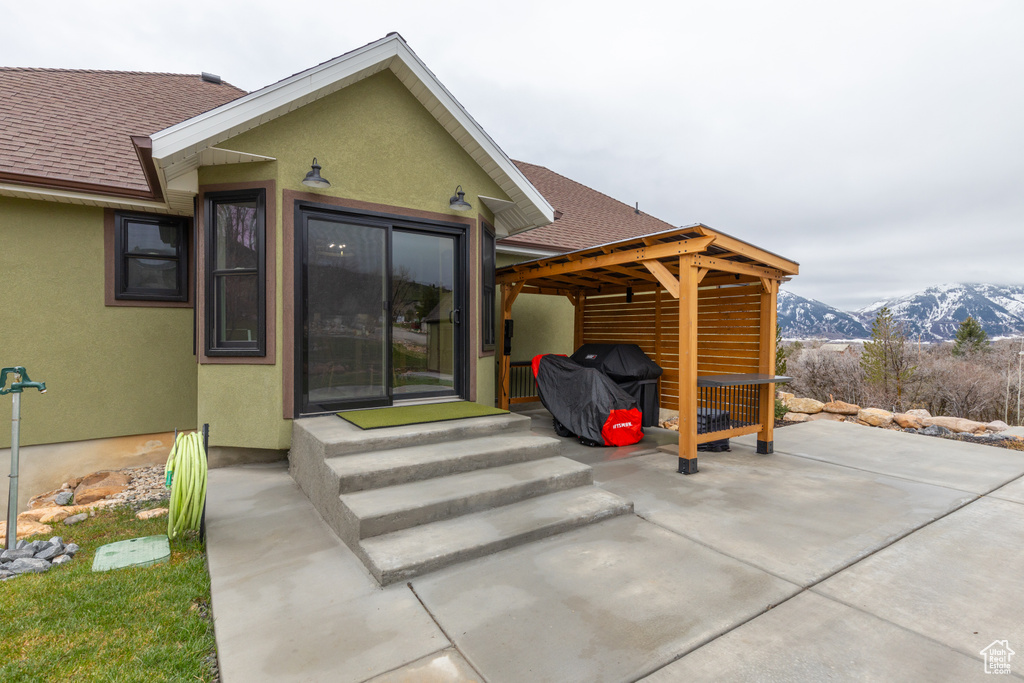 Rear view of property featuring a patio area and a mountain view