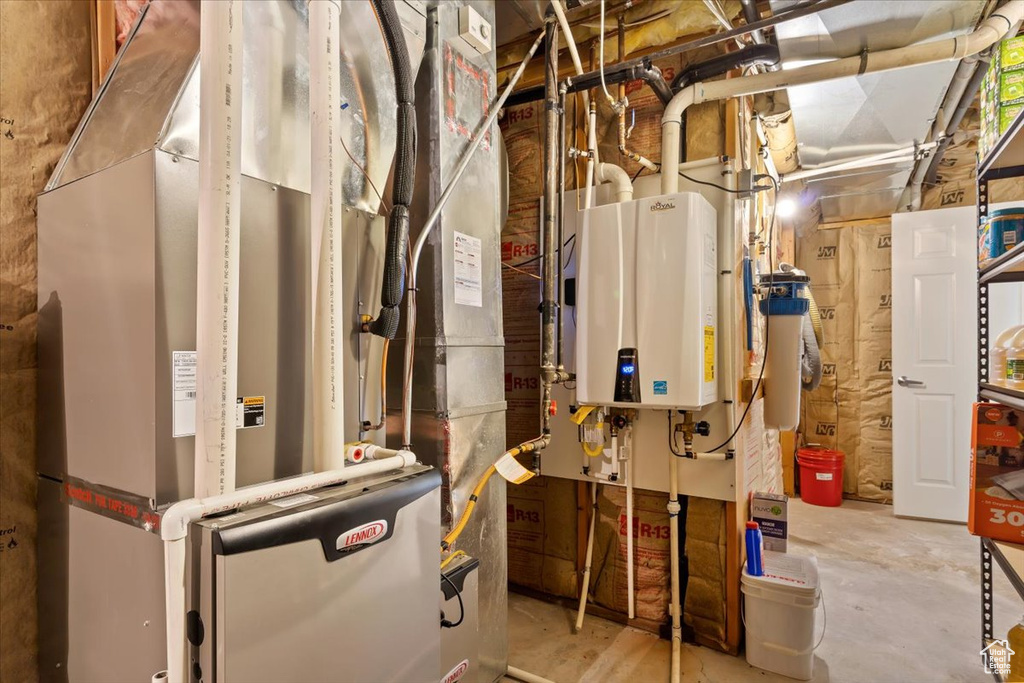 Utility room with heating utilities and tankless water heater