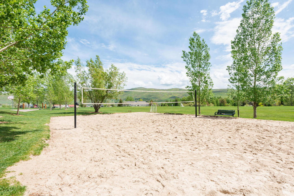 View of nearby features with volleyball court and a yard