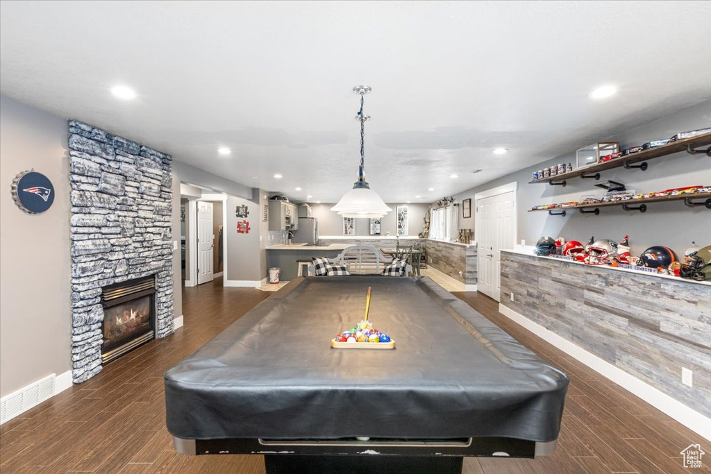 Rec room featuring a stone fireplace, billiards, and dark hardwood / wood-style floors